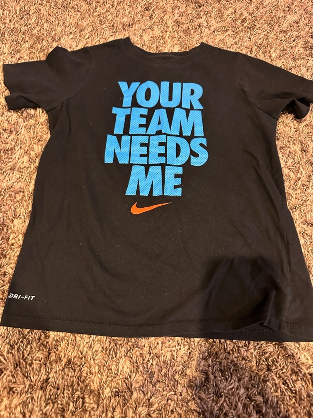 Nike Black Tee with Blue 'YOUR TEAM NEEDS ME' Text and Orange Swoosh